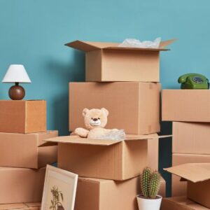 image shows a stack of boxes with various items scattered on and around them